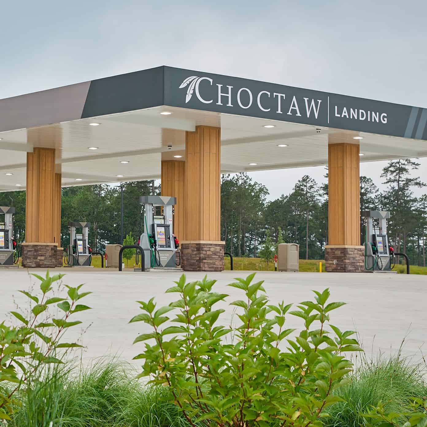 A black gas nozzle with the Choctaw "C" logo is being set in its place at a gas station.