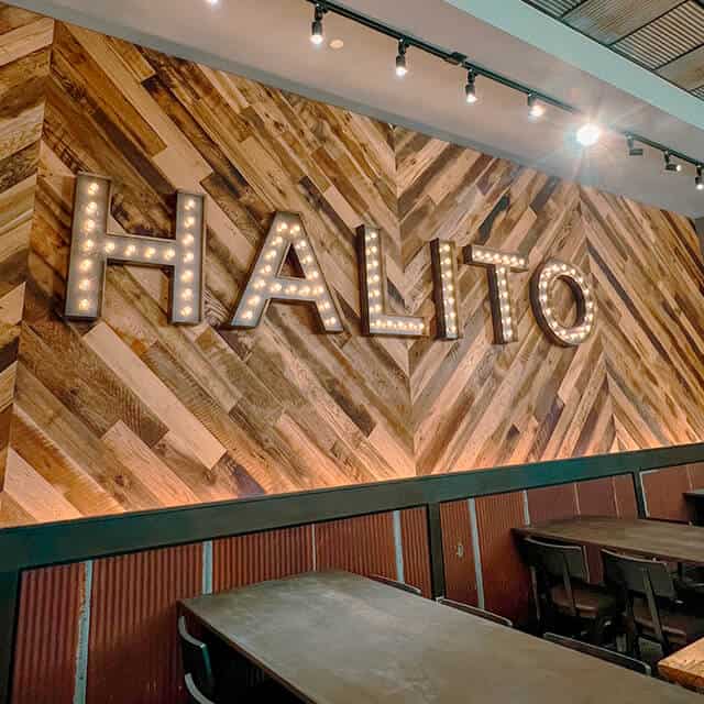 A wood-paneled wall has the word "Halito" in decorative lettering.