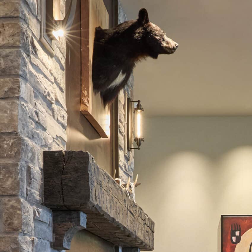 A black bear head is mounted above a fireplace in the lobby of Choctaw Landing.