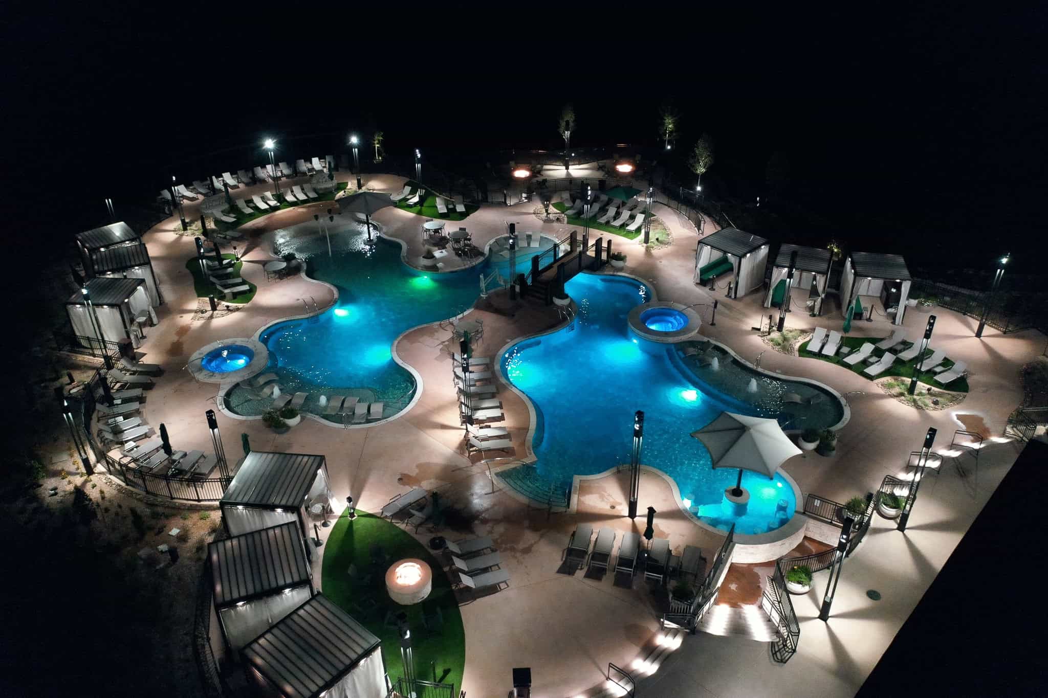 A nighttime aerial photo of the Oka Sita pool area