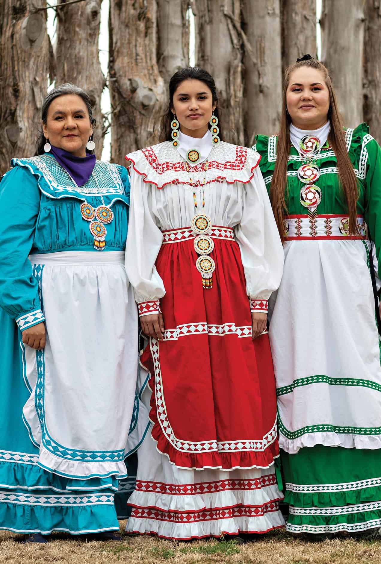 A trio of Choctaw women with traditional dress on.